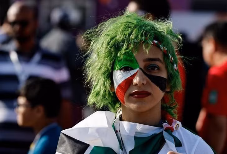 An Iran fan wearing face paint outside the stadium before their match against England. (Photo: Reuters)