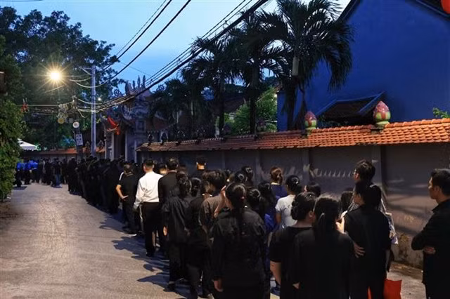 People queue up until night to pay their respect to to Party General Secretary Nguyễn Phú Trọng in his hometownin Đông Hội Commune of Hà Nội's Đông Anh District.