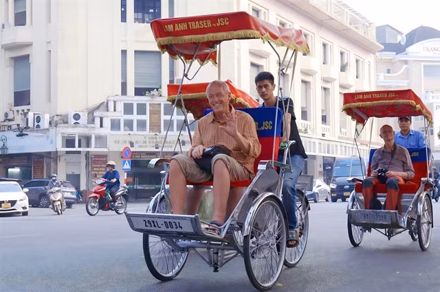 Foreign tourists enjoys a cyclo ride, one of Hà Nội's tourism products. VNA/VNS Photo Lương Tuấn Đức