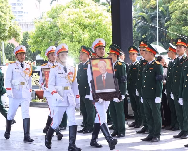 A staff of the ceremonial team moves the portrait of Party General Secretary Nguyễn Phú Trọng to the State funeral ceremony's location. — VNA/VNS Photo