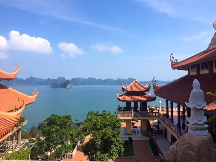 Cai Bau Pagoda is nestled against a mountain range and faces Bai Tu Long Bay