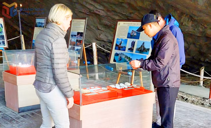 Visitors explore the exhibition area inside Tien Ong cave.