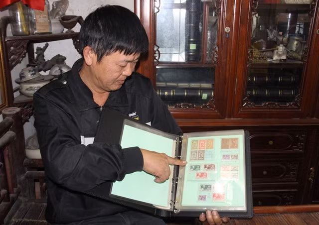PROUD COLLECTOR: Vũ Hoài Nam has the largest stamp collection in the northern province of Nam Định. VNS Photos Nguyễn Kiều Trinh