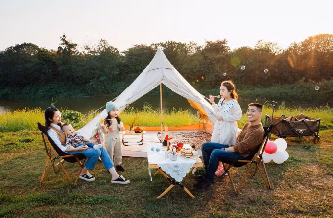 Tran Gam and her family celebrate their youngest son’s birthday by camping on the Hong River in 2021. Photo courtesy of Gam