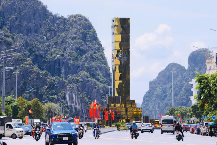 The clock tower in Hong Gai ward stands out even more amid the vibrant red of flags.