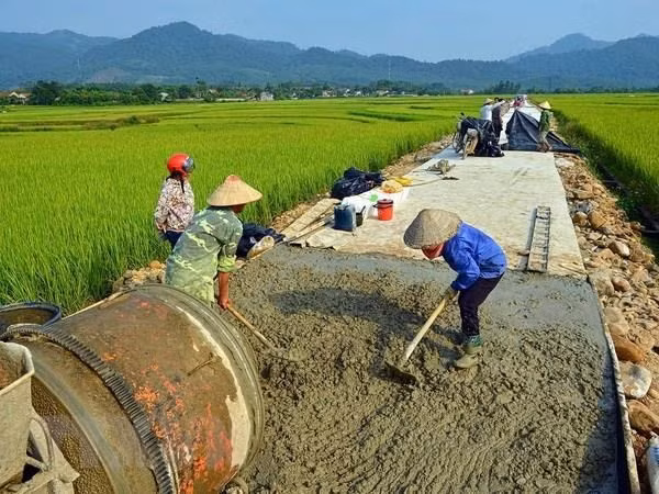 Construction of a concrete road in northern Việt Nam. The country has set a goal to transform Việt Nam's rural areas into modern, developed agricultural production centres.