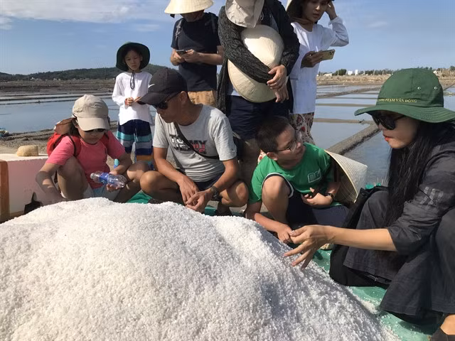 FEELING SALTY: School students join a trip to the Sa Huỳnh salt fields in Quảng Ngãi Province's Đức Phổ town. The centre of salt production offers tourism and education as two key factors for sustainable development. Photo courtesy of SAHU