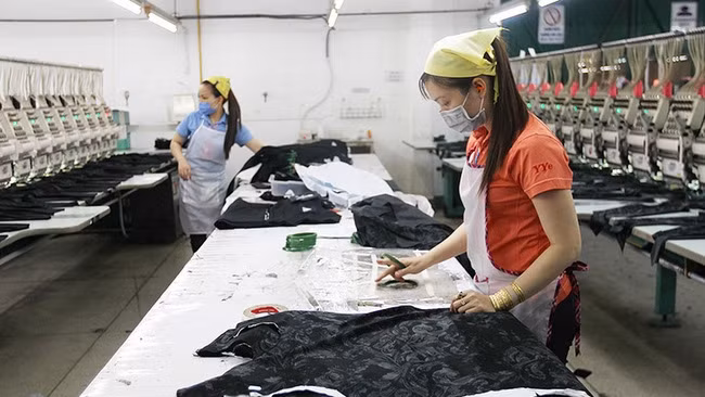 Workers from Yung Yang Embroideries Limited Company in Tan Phu District, Ho Chi Minh City, maintained production during social distancing days.