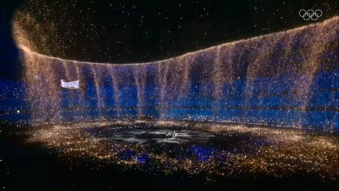 A display of luminous colours swirl together, representing the many flags of the world. (Photo: Tokyo 2020)