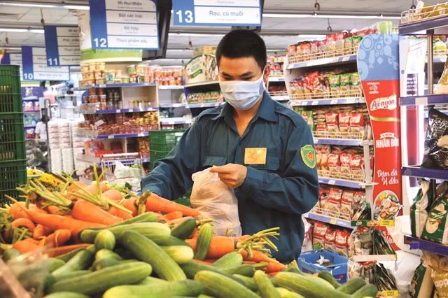 A soldier selecting food at a supermarket in HCM City. — VNA/VNS Photo Thanh Vũ
