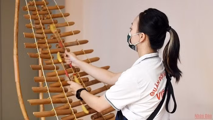 Tuning the bamboo xylophone.