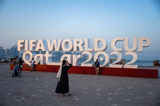 Visitors take photos in front of a FIFA World Cup sign in Doha on October 23. The competition will be broadcast in Việt Nam by State-owned VTV