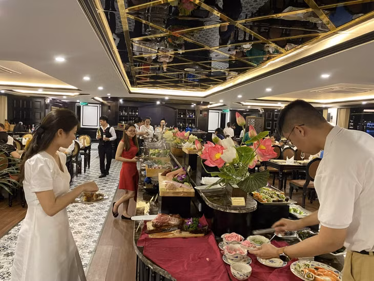 Tourists enjoy a meal on a Ha Long Bay cruise.