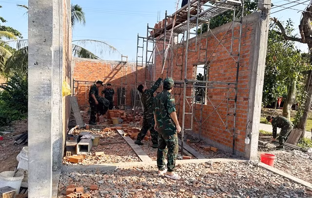 Military officers build a new home for a family in Cần Thơ City, replacing their old dilapidated house, on February 10.