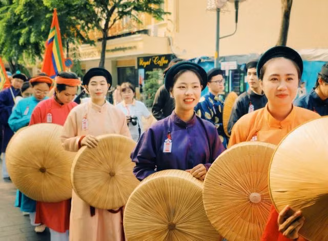 FESTIVE FEELINGS: Young women in HCM City are eager to join the parade.