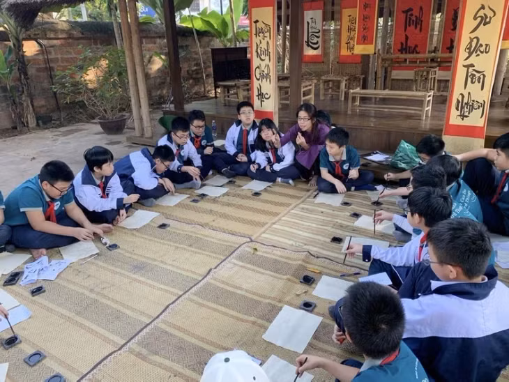 Children try calligraphy writing at the Temple of Literature in Hanoi