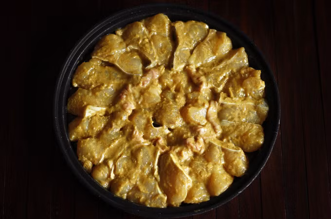 When marinated, the fish is enveloped in a thick, yellow sauce. Photo by VnExpress/Bui Thuy