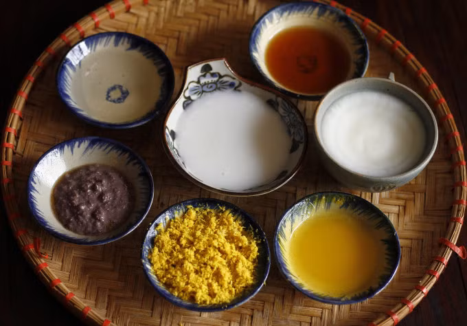 After filtering, the sour Vietnamese fermented rice reveals a milky white color. Photo by VnExpress/Bui Thuy