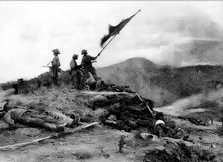 Soldiers wave the flag after taking over Him Lam, a key destination on the battlefield.