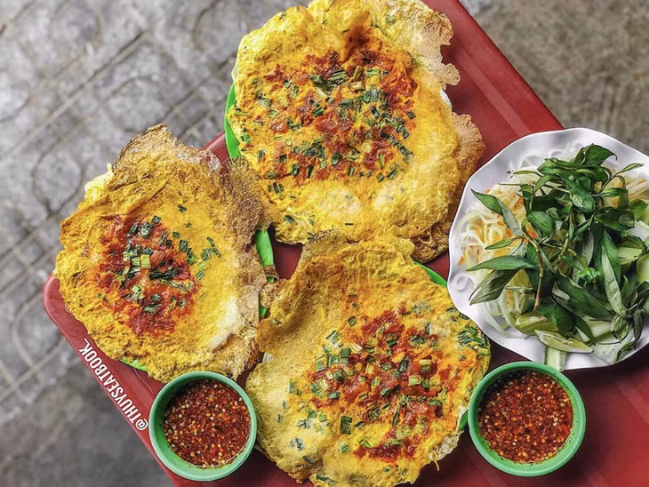Hue-style crepe is served with pickled papaya, Vietnamese cilantro and cucumber. Photo courtesy of Thuyseatbook