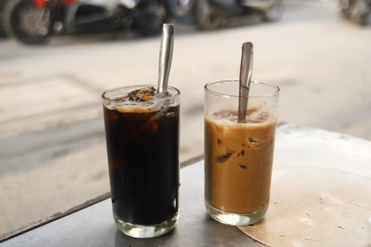 Two cups of iced black coffee (L) and iced coffee with condensed milk at a shop on Phan Dinh Phung Street in HCMC. Photo by Di Vy