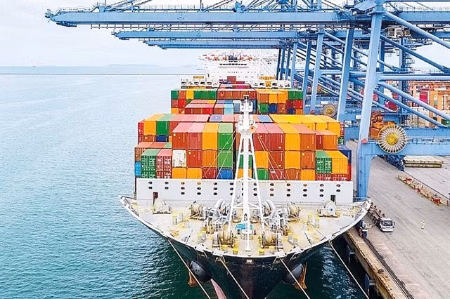 Goods are loaded for exports at a port in northern region. A slowdown in Việt Nam’s trade surplus was one of the temporary disadvantages for the domestic exchange rate. Photo thoibaotaichinhvietnam.vn