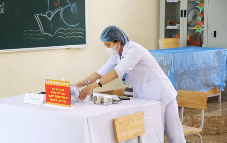 Medical workers check essential equipment to ensure safe conditions for vaccination.
