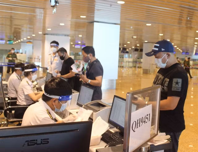 Internaitonal tourists have documents checked at Cam Ranh Airport in south central Khánh Hòa Province. All arrivals in Việt Nam will not have to make health declarations from April 27.