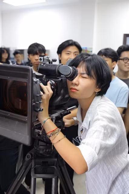 A student at the Cinema Department, University of Theatre and Performing Arts of Hà Nội practises film shooting. Photo courtesy of the university