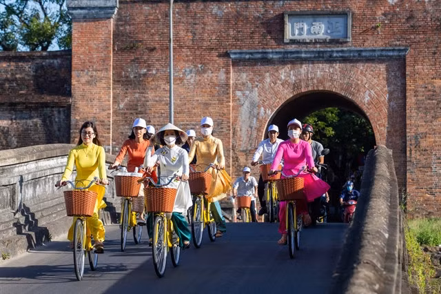 Tourists on a bicycle tour in Huế City. Quảng Nam, Thừa Thiên Huế and Đà Nẵng have been building a 'green' tourism destination in central Việt Nam. Photo courtesy of UNDP
