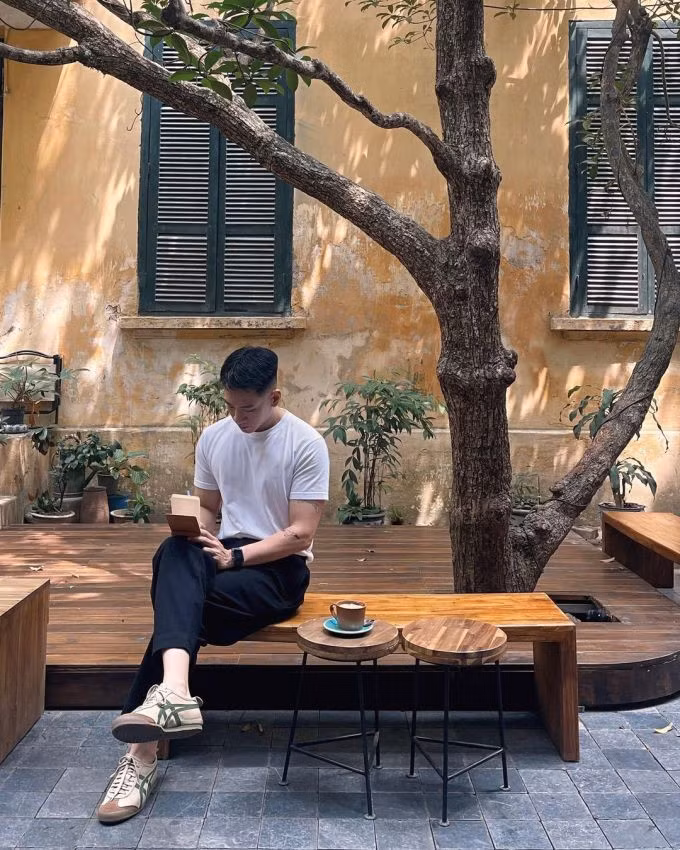 A man drinks coffee at Tranquil Books &amp; Coffee on Cao Ba Quat Street, Hanoi. Photo courtesy of Instagram/miinhmin
