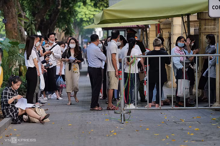 People wait outside Hanoi's Consular Department to complete immigration procedures, primarily for studying and working abroad, Sept. 7, 2022. Photo by VnExpress/Ngoc Thanh