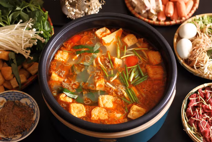 Pieces of crab paste and fried tofu rise to the surface in a perfect pot of lau rieu cua. Photo by VnExpress