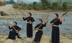 Members of the Binh Lieu commune Then Singing Club perform beside a stream.