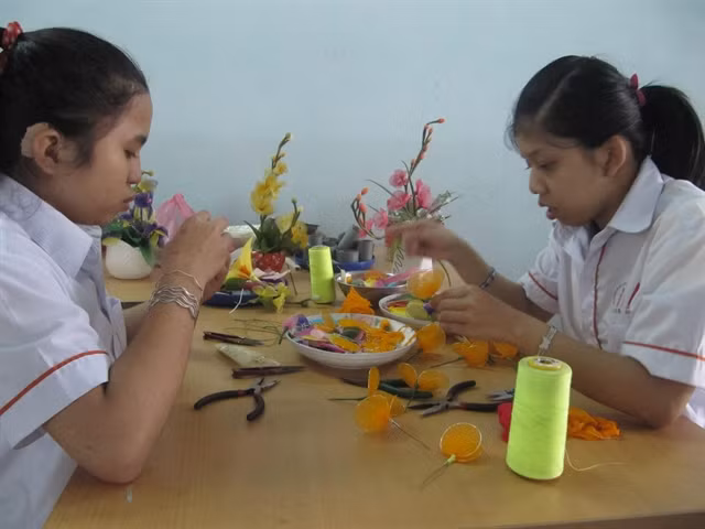 Two Agent Orange girls receive vocational training and care at the Đà Nẵng City's Centre for AO children and people. — VNS Photo Công Thành